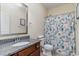 Clean bathroom with granite countertop, shower, and a patterned curtain at 794 Thistle Trail, Calabash, NC 28467