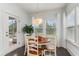 Charming breakfast nook with a round table and four chairs, near backyard access at 794 Thistle Trail, Calabash, NC 28467