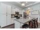 Modern kitchen with white cabinets, granite countertops, and stainless steel appliances at 794 Thistle Trail, Calabash, NC 28467