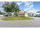 Two-story house with beige siding and a garden, viewed from across the street at 1356 Tranquility Ln., Myrtle Beach, SC 29577