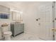 Modern bathroom with gray vanity, marble-look floors, and updated lighting at 1356 Tranquility Ln., Myrtle Beach, SC 29577