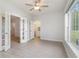 Bright sunroom with multiple windows, ceiling fan, and access to laundry at 500 Willow Greens Dr. # B, Conway, SC 29526