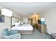 Two beds, armchair, and access to kitchenette at 1105 S Ocean Blvd. # 1044, Myrtle Beach, SC 29577