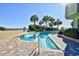 Relaxing kidney-shaped swimming pool with palm trees nearby at 1105 S Ocean Blvd. # 1044, Myrtle Beach, SC 29577