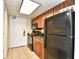 Kitchen with black appliances and wood cabinets at 1105 S Ocean Blvd. # 1044, Myrtle Beach, SC 29577