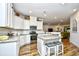 Open concept kitchen with granite island and stainless steel appliances at 437 Oaklanding Ln., Murrells Inlet, SC 29576