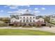 Exterior view of a charming clubhouse with patio and golf cart at 1009 World Tour Blvd. # 105, Myrtle Beach, SC 29579