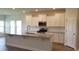 Modern kitchen with white cabinets, granite counters, and a large island at 6060 Zoe Way, Myrtle Beach, SC 29588
