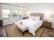 Main bedroom with large windows, plush bed, and wood flooring at 6088 Zoe Way, Myrtle Beach, SC 29588