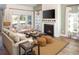 Bright living room boasts a fireplace, ample seating, and large windows at 6088 Zoe Way, Myrtle Beach, SC 29588
