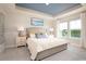 Main bedroom with a tray ceiling, large windows, and soft color palette at 5042 Selene Ct., Myrtle Beach, SC 29588