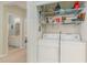 Convenient laundry room with washer, dryer, and storage shelves at 601 Hillside Dr. N # 3906, North Myrtle Beach, SC 29582