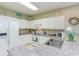 White kitchen with granite counters and stainless steel appliances at 601 Hillside Dr. N # 3906, North Myrtle Beach, SC 29582