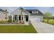 One-story home with gray siding, white trim, two-car garage, and palm trees at 5050 Selene Ct., Myrtle Beach, SC 29588