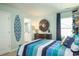 Bright bedroom with striped bedding, dresser, and ensuite bathroom at 5054 Selene Ct., Myrtle Beach, SC 29588