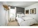 Spacious bedroom with a white bed, gray accent wall, and floating shelf at 5054 Selene Ct., Myrtle Beach, SC 29588