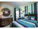Well-lit bedroom featuring a striped bedspread and ocean-themed decor at 5054 Selene Ct., Myrtle Beach, SC 29588
