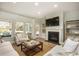 Spacious living room featuring a fireplace, large windows, and ample natural light at 5054 Selene Ct., Myrtle Beach, SC 29588