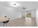Bright living room with wood-look floors and sliding glass doors to balcony at 1301 Pridgen Rd. # 1008, Myrtle Beach, SC 29577