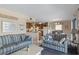 Living room with blue striped couches and view of kitchen at 5905 S Kings Highway # 219-B, Myrtle Beach, SC 29575