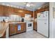 Kitchen boasts wood cabinets and a white refrigerator at 5905 S Kings Highway # 219-B, Myrtle Beach, SC 29575