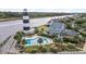 Aerial of house, pool, and lighthouse by waterway at 4755 Lightkeepers Way # 15-F, Little River, SC 29566