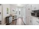 White kitchen cabinets, stainless steel appliances and vinyl flooring at 4755 Lightkeepers Way # 15-F, Little River, SC 29566