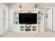 White built-in entertainment center with shelves and a large TV at 4755 Lightkeepers Way # 15-F, Little River, SC 29566