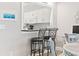 Kitchen features a pass-through, white cabinets, and black countertops at 4755 Lightkeepers Way # 15-F, Little River, SC 29566