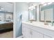 Bright bathroom with double sinks, and a view of bedroom at 4755 Lightkeepers Way # 15-F, Little River, SC 29566