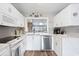 Well-equipped kitchen with white cabinets, modern appliances, and quartz countertops at 4755 Lightkeepers Way # 15-F, Little River, SC 29566