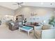 Living room boasts a sectional sofa, coffee table, and access to a balcony at 4755 Lightkeepers Way # 15-F, Little River, SC 29566