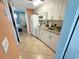 Clean and functional kitchen with white cabinets and a view into the living area at 2000 Ocean Blvd. S # 306, Myrtle Beach, SC 29577