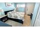 King-size bed in a light blue, beachy bedroom with ocean views at 2000 Ocean Blvd. S # 306, Myrtle Beach, SC 29577