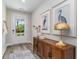 Bright entryway with wood-look floors, a stylish console table, and a view to the backyard at 7046 Shooting Star Way, Myrtle Beach, SC 29579