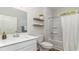 Clean bathroom with a white vanity, tub shower combo, and floating shelves at 7046 Shooting Star Way, Myrtle Beach, SC 29579
