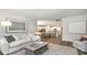 Open living room with view into kitchen, featuring a comfortable sofa and coffee table at 7046 Shooting Star Way, Myrtle Beach, SC 29579