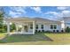 House with covered patio and grassy backyard at 7046 Shooting Star Way, Myrtle Beach, SC 29579