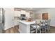 Bright kitchen featuring white cabinets, stainless steel appliances, and an island with seating at 7046 Shooting Star Way, Myrtle Beach, SC 29579
