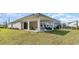 Covered patio and grassy backyard with view of neighbor's pool at 7046 Shooting Star Way, Myrtle Beach, SC 29579