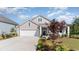 Gray house with white garage door and landscaping at 7046 Shooting Star Way, Myrtle Beach, SC 29579