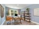 Home office with a wooden desk, built-in shelving, and a calming blue color at 7046 Shooting Star Way, Myrtle Beach, SC 29579
