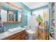 Bathroom with teal walls, a shower/tub combo, and updated vanity at 6001-5027 S Kings Hwy., Myrtle Beach, SC 29575