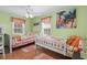 Bright bedroom with two twin beds, wood floors, and beach themed decor at 6001-5027 S Kings Hwy., Myrtle Beach, SC 29575