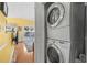 Stackable washer and dryer in a closet, with a view of the living room at 6001-5027 S Kings Hwy., Myrtle Beach, SC 29575