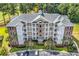 Exterior view of multi-story building and parking at 4870 Luster Leaf Circle # 401, Myrtle Beach, SC 29577