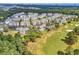 Aerial view of community with buildings, golf course, and ocean views at 4870 Luster Leaf Circle # 401, Myrtle Beach, SC 29577