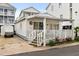 Quaint beach cottage with covered porch and small front yard at 6001-1092 S Kings Hwy., Myrtle Beach, SC 29575