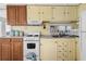 Cozy kitchen with wood cabinets and white appliances at 6001-1092 S Kings Hwy., Myrtle Beach, SC 29575