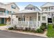 Charming white cottage with a spacious front porch and well-manicured landscaping at 6001-1092 S Kings Hwy., Myrtle Beach, SC 29575